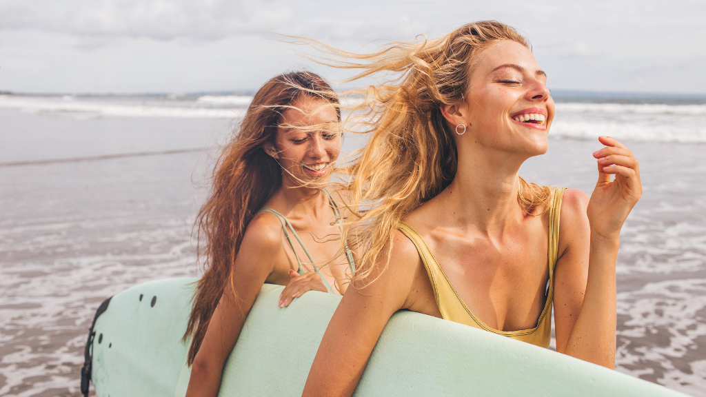 Girls surfing at Noku Beach House, Seminyak, Bali